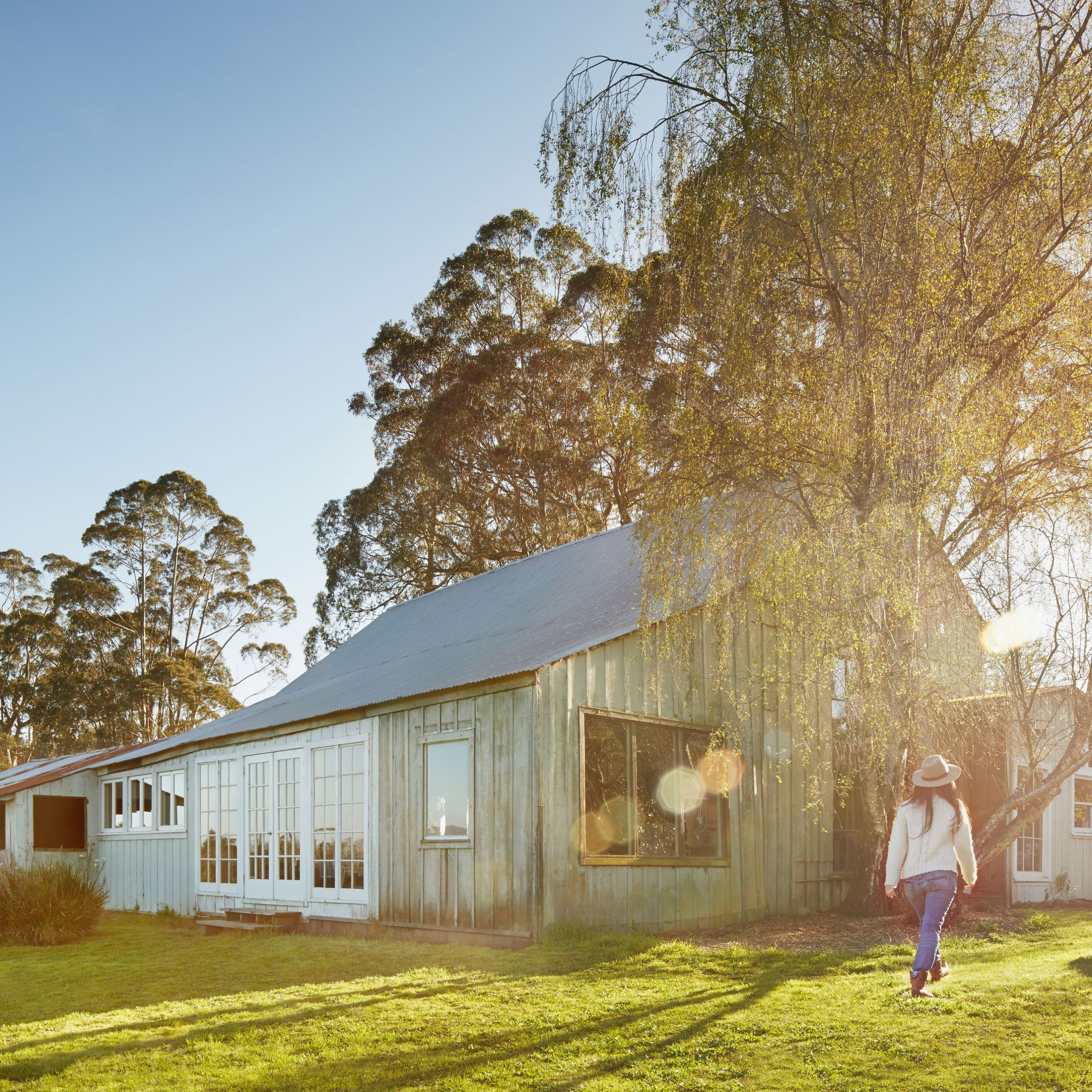 chinese woman walking in backyard of barn house 599e e1a d8f64