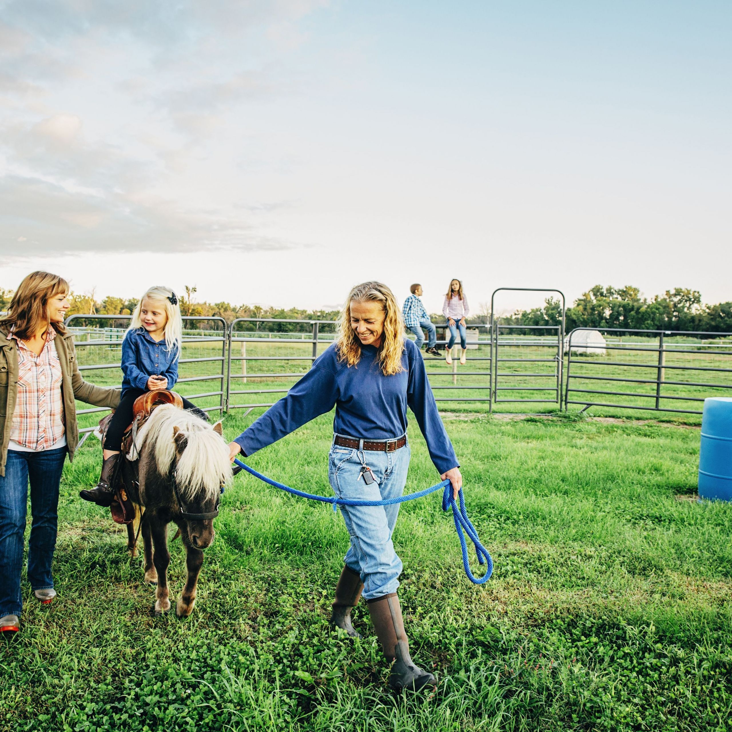 three generations of caucasian women walking miniature horse on farm 5c27babfc9e77c0001dbc0fd